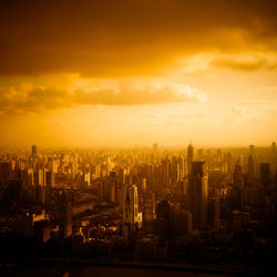 Aerial view of buildings in city against sky during sunset