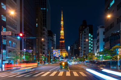 Road leading towards tokyo skytree in city at night