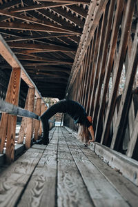 Woman exercising on footbridge