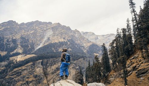 Man standing on mountain against sky