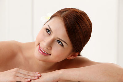 Smiling shirtless young woman at home