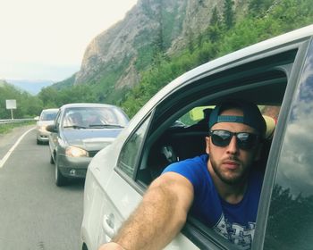 Portrait of young man in car