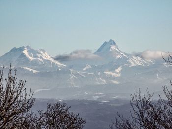 Scenic view of snowcapped mountains against clear sky