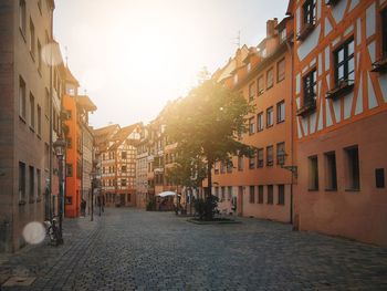 Street amidst buildings in town against sky