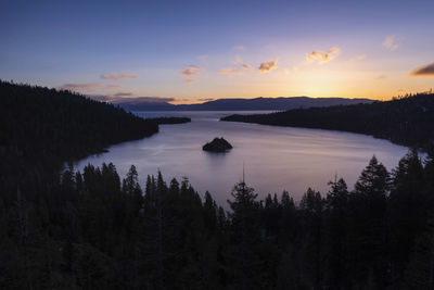 Scenic view of lake against sky at sunset