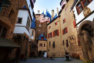 Low angle view of buildings in town against sky