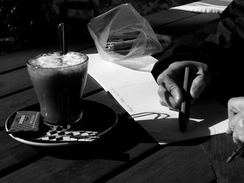 Close-up of man with drink served on table