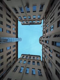 Low angle view of buildings against blue sky