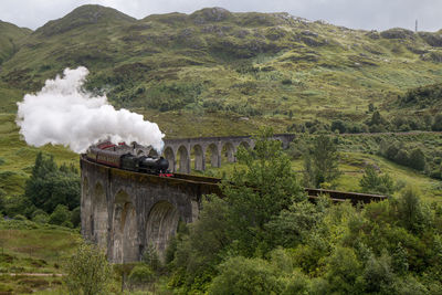 Smoke emitting from train on bridge