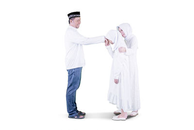 Portrait of friends standing against white background