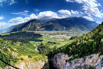 Scenic view of field and mountains against sky