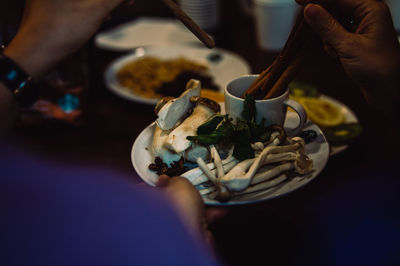 Midsection of person holding ice cream in bowl