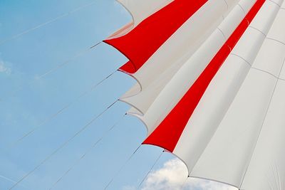 Low angle view of parasol against blue sky