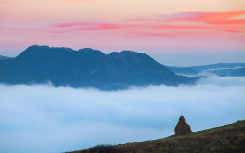 Scenic view of mountains against cloudy sky