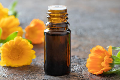 Close-up of yellow flower in glass on table