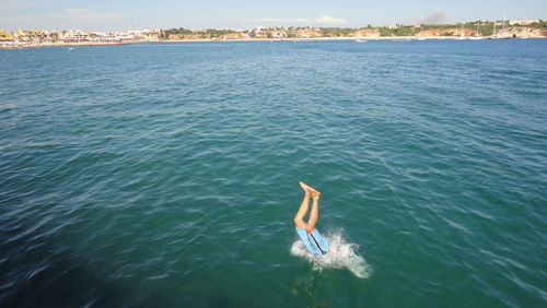 Low section of man diving in sea