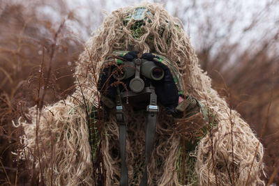 Kikimora soldier with binoculars in his hands