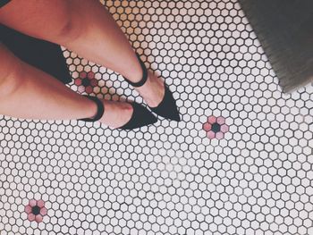 Low section of woman on patterned floor