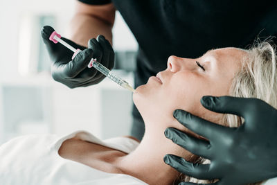 Young woman gets beauty facial injections in salon or clinic. skincare concept