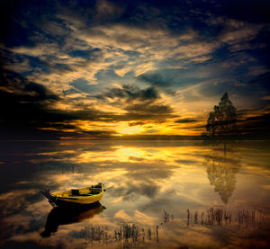 Boat moored on sea against sky during sunset