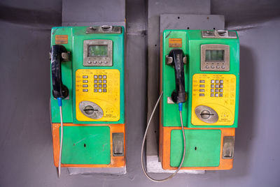 Close-up of pay phones on wall