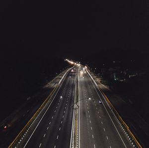 High angle view of light trails on highway at night