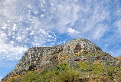 Low angle view of rock formations against sky