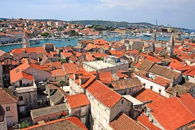 High angle view of town by sea against sky