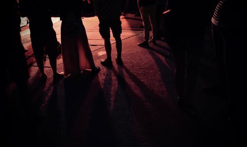 Low section of people walking at night