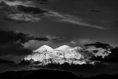 Low angle view of mountain against dramatic sky