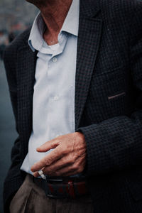 Midsection of man wearing suit