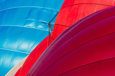 Low angle view of multi colored balloons against sky