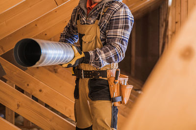 Rear view of man working in workshop