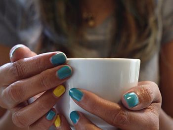 Midsection of woman holding coffee cup