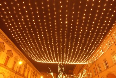 Low angle view of illuminated ceiling at night