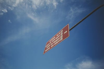 Low angle view of information sign against sky