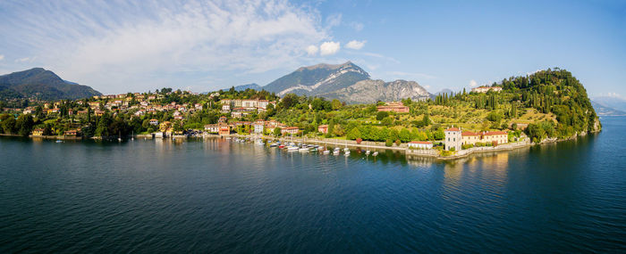 Panoramic view of city by sea against sky