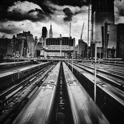 Railroad tracks in city against sky