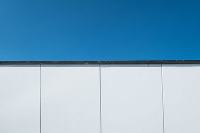 Low angle view of built structure against clear blue sky