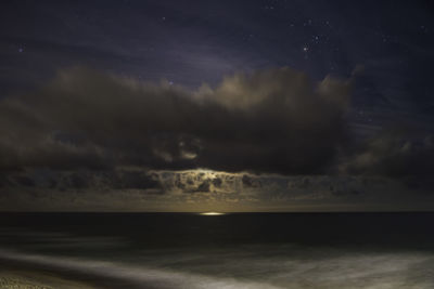 Scenic view of sea against sky at night