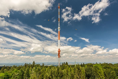 Low angle view of communications tower against sky