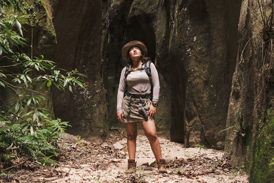 Portrait of young woman looking away in forest