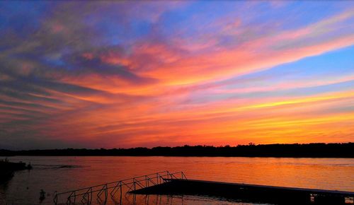 Scenic view of lake against orange sky