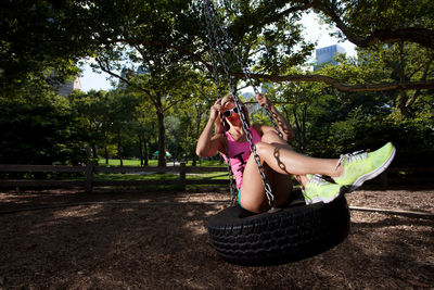 Full length of woman on swing at park