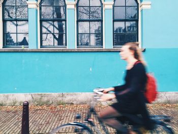 Side view of woman riding bicycle