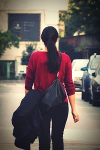 Rear view of woman standing in park