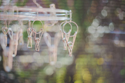 Close-up of clothespins hanging outdoors