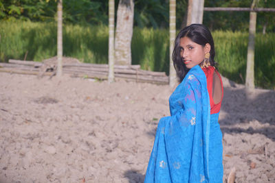 Portrait of smiling girl standing on land