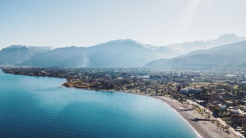 Scenic view of sea with mountain range in background