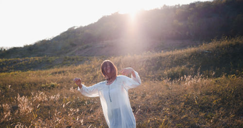 Smiling woman standing on field